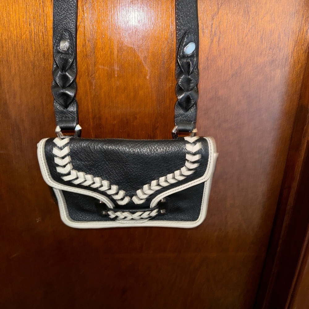 Oryani black pebble leather crossbody .